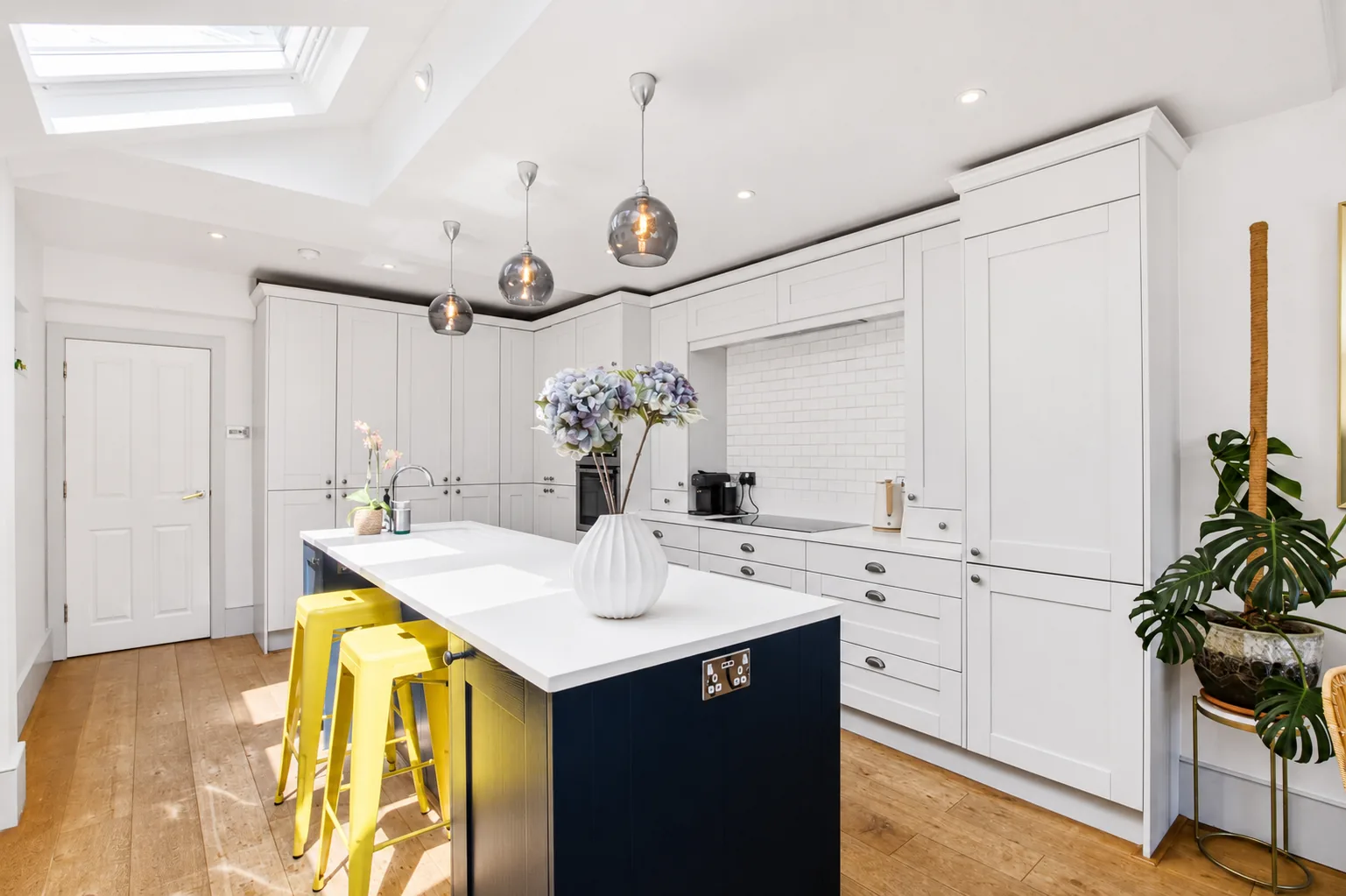 Bright guest-ready kitchen with fitted cabinetry and a prepared island.