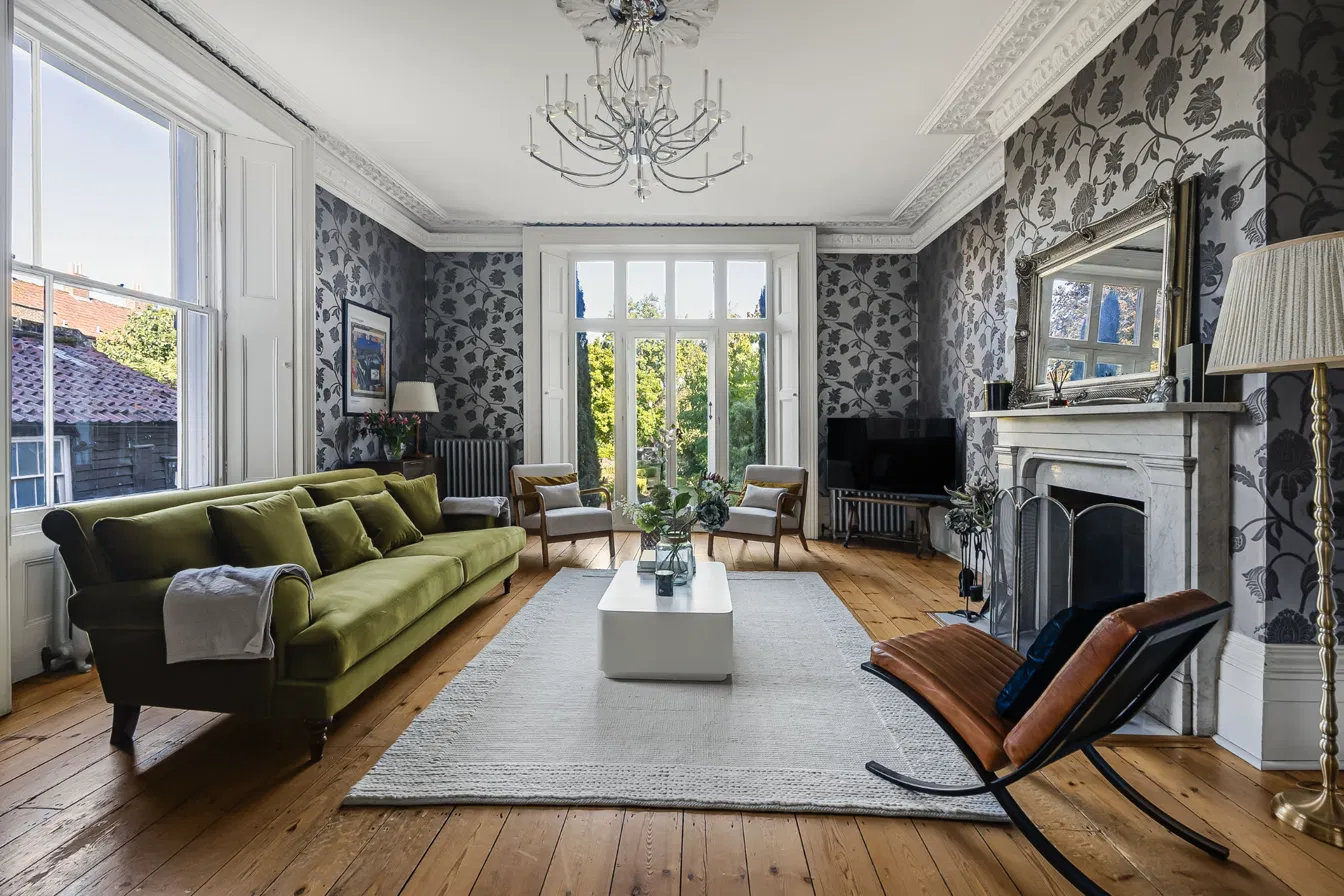 Period reception room with marble fireplace in a Hertford short-let managed by Hostahome