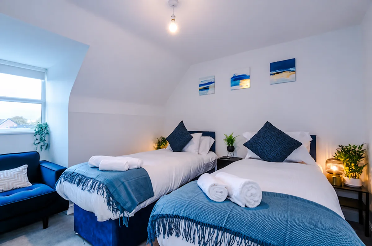 Twin bedroom with blue accents in the Wythenshawe house