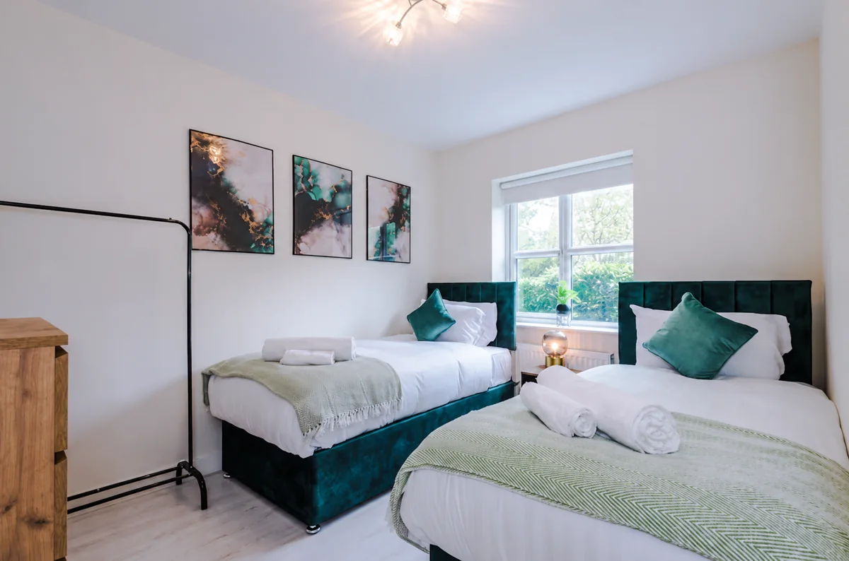 Twin bedroom with green accents in the Wythenshawe house