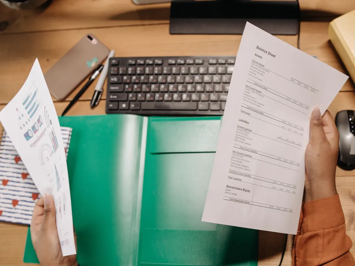 Printed statements and reports laid out on a desk