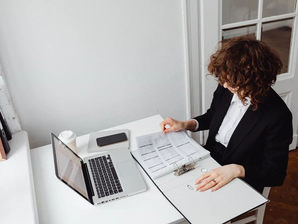 Booking details being checked against paperwork at a desk