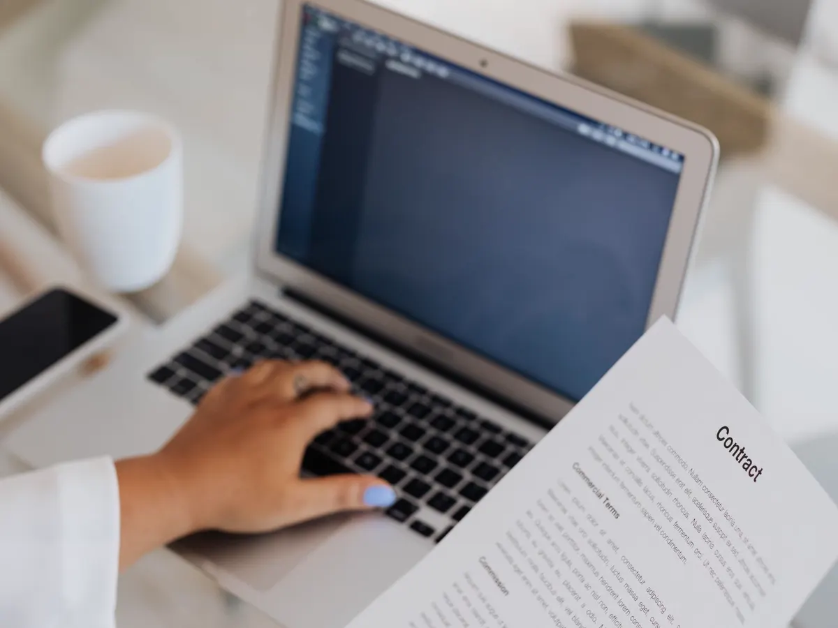 Written terms being read on a laptop at a desk